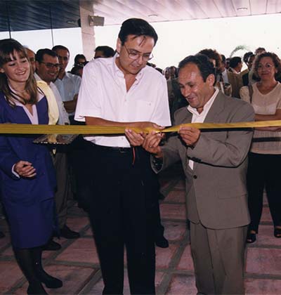 men cutting an inaugural ribbon